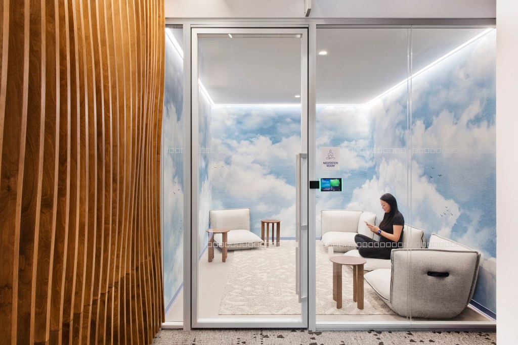 Modern office meditation room with calming design for employee wellbeing.