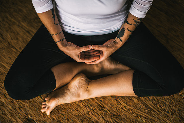 A person in a comfortable seated meditation position